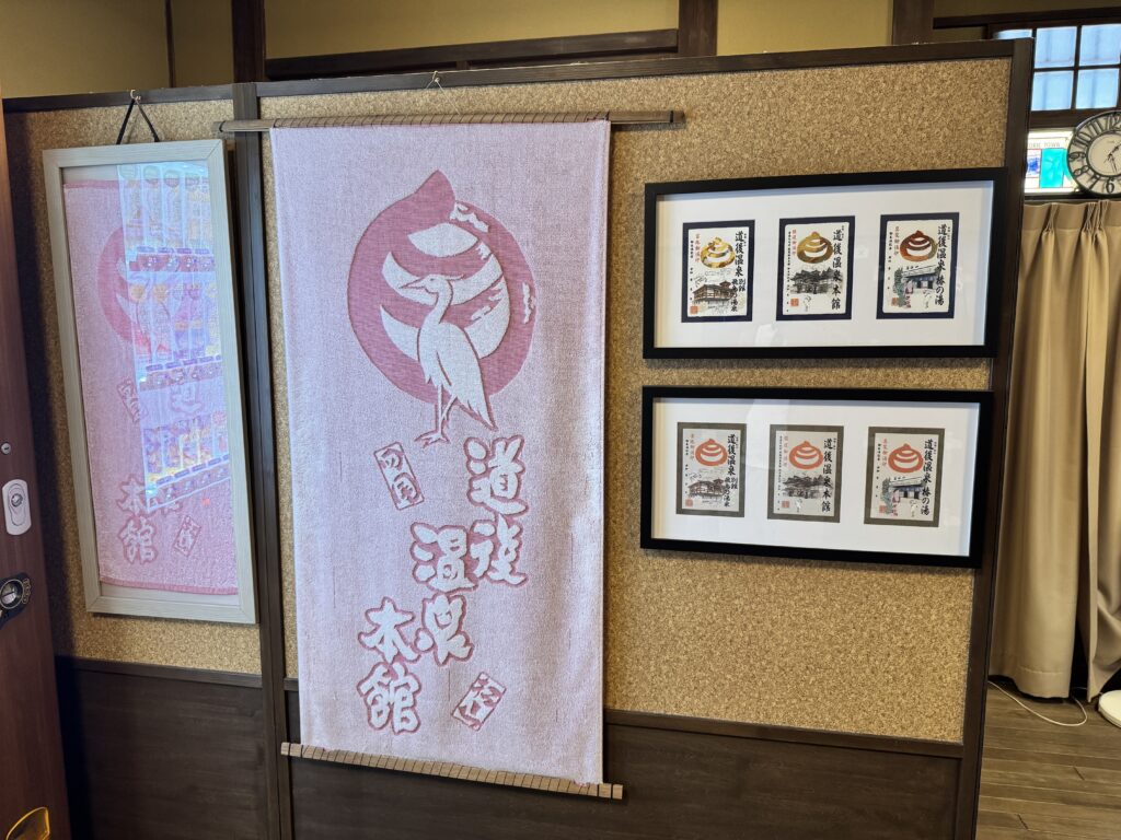 道後温泉本館のタオルと御湯印の展示。入浴記念に購入できるグッズも豊富で旅の思い出にぴったり。